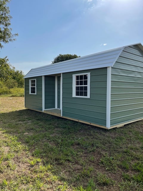green shed with a white roof